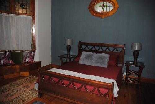 a bedroom with a bed and two lamps and a window at Charming 3 bedroom house -No Loadshedding in Pretoria