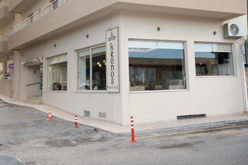a white building with a sign on the side of it at Kronos Hotel in Heraklio Town