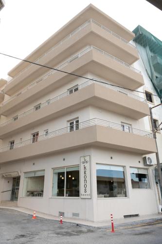 a large white building with a lot of windows at Kronos Hotel in Heraklio Town