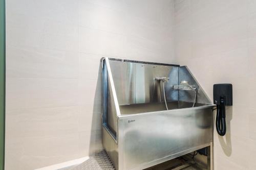 a metal sink in the corner of a bathroom at Rock Mill - Deluxe Studio Apartments in Stoney Middleton