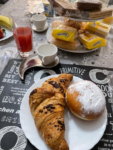 a table with a plate of bread and pastries on it at B&B Bovianum in Boiano