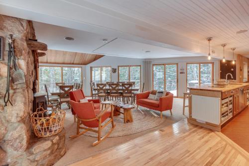 a living room filled with furniture and a stone wall at White Mountain Escape with Separate In-Law Suite! in Thornton