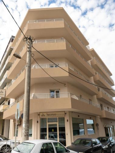 a building with cars parked in front of it at Kronos Hotel in Heraklio Town