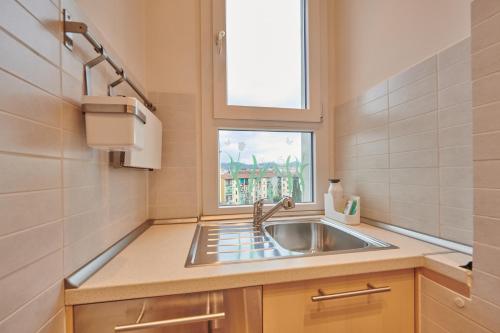 a kitchen with a sink and a window at Casa Gordigiani - bilocali con parcheggio in Florence