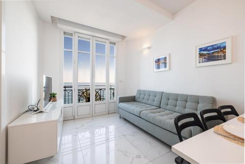 a living room with a couch and a table at Sea view - 2 Bdr Promenade des Anglais in Nice