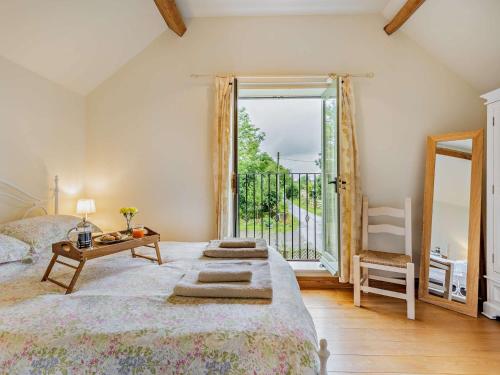 a bedroom with a bed and a large window at 2 Bed in Church Stretton 76622 in Rushbury