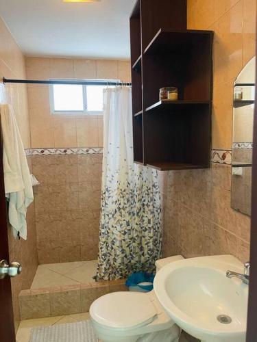 a bathroom with a shower and a toilet and a sink at Casa con piscina súper bonita ! in Salinas