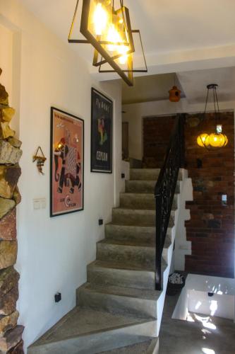 a staircase in a house with a chandelier at Villa Olde Ceylon in Kandy