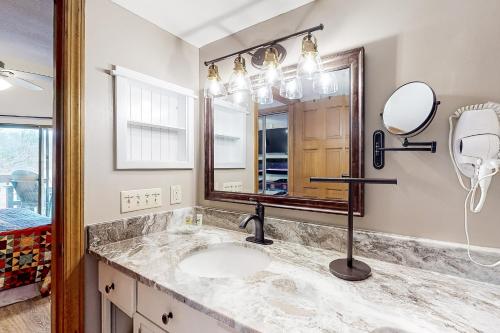 a bathroom with a sink and a mirror at Eagles Nest Escape in Gatlinburg