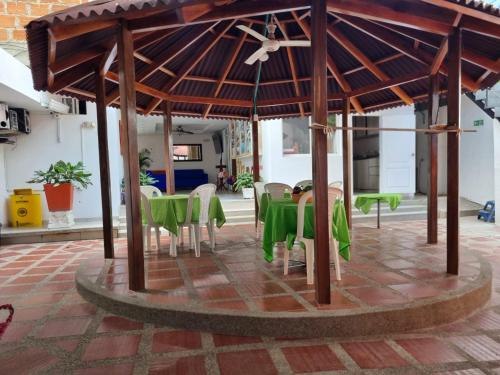a group of green tables and chairs under a pavilion at Hotel Mayte in Fonseca