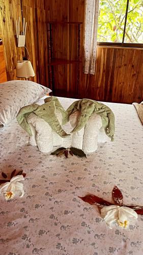 a person laying on a bed in a bedroom at Río Celeste, Cacahua Lodge in Rio Celeste