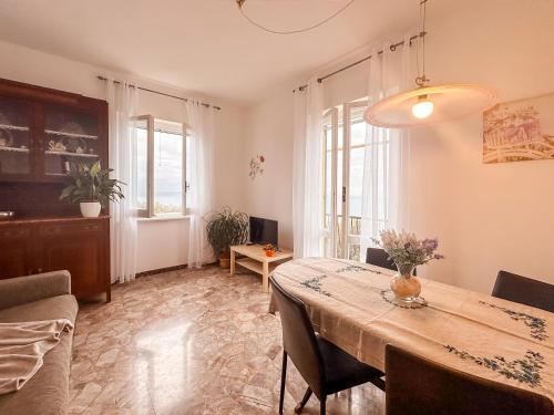a dining room with a table and some chairs at [5 TERRE]The Terrace on the Gulf - Parking / Wi-fi in Lavagna