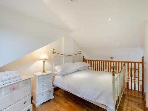 a bedroom with a white bed and a dresser at Little Batley House in Westgate-on-Sea