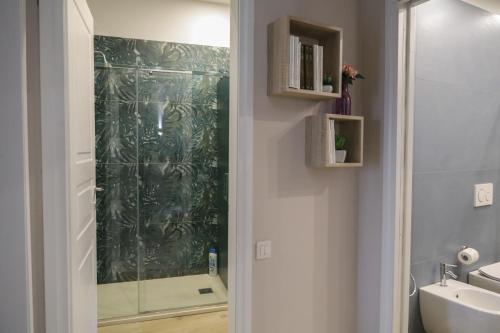 a bathroom with a shower and a sink at Accademia Apartment in Sassari