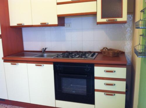 a kitchen with a sink and a stove top oven at Siracusa Vacanze in Siracusa