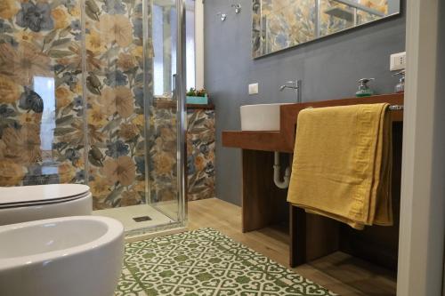 a bathroom with a sink and a shower at Accademia Apartment in Sassari