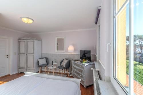 Ένα ή περισσότερα κρεβάτια σε δωμάτιο στο Hotel Villa Wahnfried Thiessow