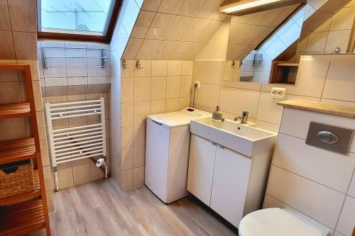 a small bathroom with a sink and a toilet at Wohnung am Meer mit Garten in Stralsund