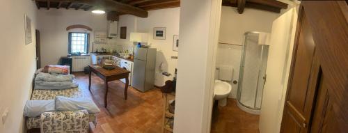 eine Küche und ein Wohnzimmer mit einem Tisch in der Unterkunft Apartment on 2 floors for 2 to 4 guests in Donnini
