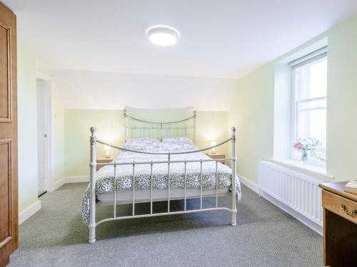 a white bed in a room with a window at 2 Bed in Westward Ho 80350 in Northam