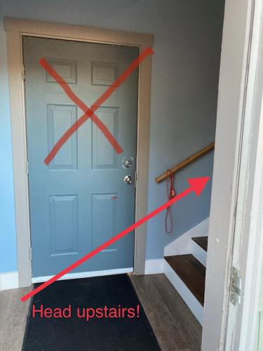 a door with a red x on it next to a stairs at Lakeview Condo at Causeway Marina in Naples