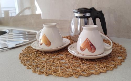 two tea pots on a table with a coffee maker at Blue Skies in Podgorica