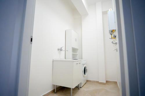 a white washer and dryer in a white room at Casa Erika in Bova Marina