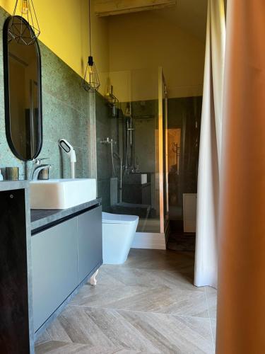 a bathroom with a tub and a sink and a shower at Viesuli Village Villa in Saraiķi