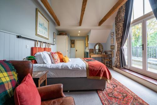 a bedroom with a large bed and a couch at The Anchor Inn in Lower Froyle