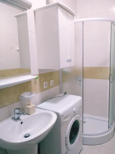 a bathroom with a washing machine and a sink at Kotor Sveti Stasije Mila in Dobrota