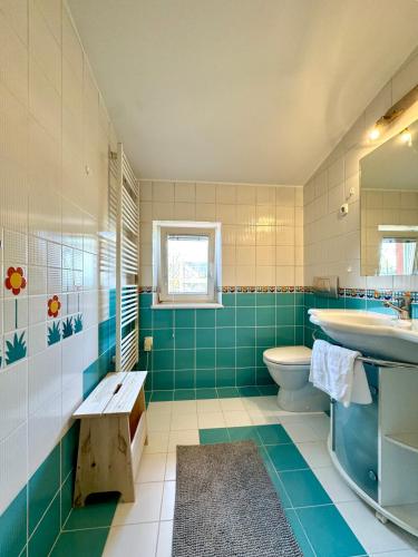 a bathroom with a sink and a toilet and a tub at Central Villa with Garden in Ljubljana