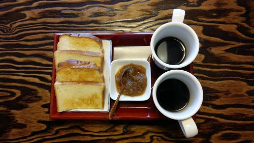 a tray with a sandwich and a cup of coffee at Greem Guesthouse in Jeonju