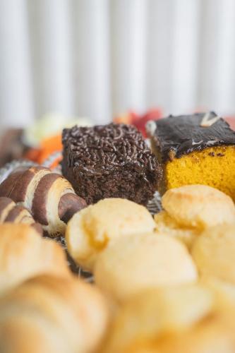 a bunch of different types of pastries on a plate at Locanda Montecielo Pousada Boutique - Vale dos Vinhedos in Bento Gonçalves