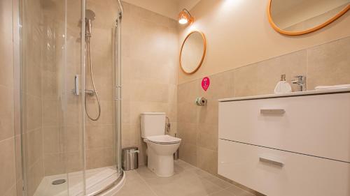 a bathroom with a shower and a toilet and a sink at VacationClub - Apartamenty Zakopiańskie Apartament 133 in Zakopane