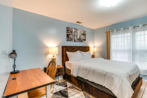 a bedroom with a bed and a table and a window at Cozy Newark Getaway about 15 Mi to Manhattan! in Newark