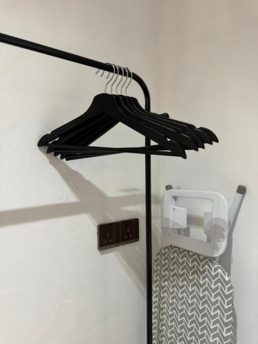 a black umbrella hanging from a wall at Stylish Balinimo Guest room - King Bed, Free Netflix, Prime & Wi-Fi Near Bukit Mertajam in Kubang Semang