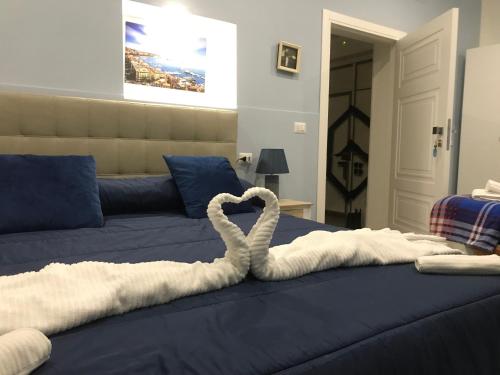 a bed with a heart made out of towels at Gloves Rooms in Naples