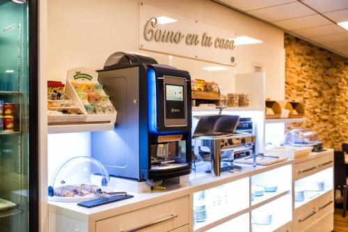 a coffee machine on a counter in a store at Hotel Alda Bonaval in Santiago de Compostela