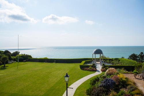 a garden with a gazebo and the ocean at Hydro Hotel in Eastbourne