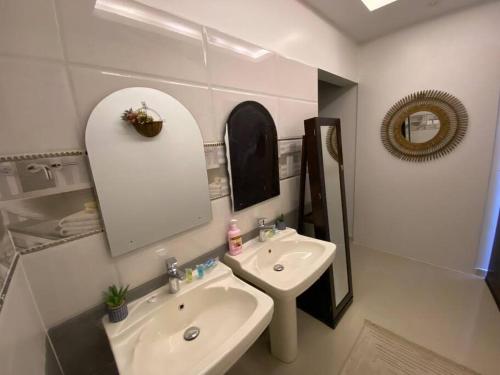 a white bathroom with a sink and a mirror at غرفه مستقله بدورة مياه حي طويق in Riyadh
