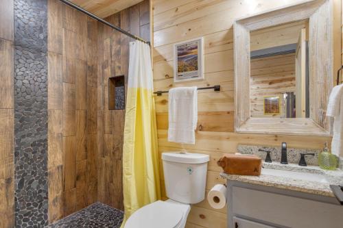 a wooden bathroom with a toilet and a shower at Pink Pines AvantStay Luxury Aesthetic Dream Home Indoor Pool Hot Tub in Pigeon Forge