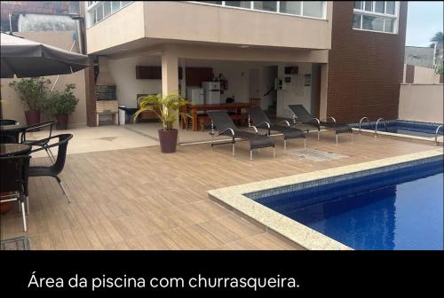 a patio with chairs and a swimming pool in front of a building at Não está disponível para locação in Ilhéus