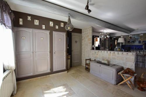 une cuisine avec des armoires blanches et un sol carrelé dans l'établissement Villa le 62 Cazan, à Vernègues