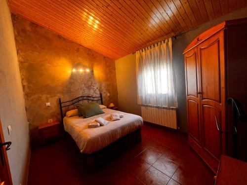 um quarto com uma cama com toalhas em la cabaña de gredos em San Martín de la Vega del Alberche