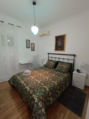 a bedroom with a bed with a comforter on it at Panormou studio comfortable max two guests in Athens