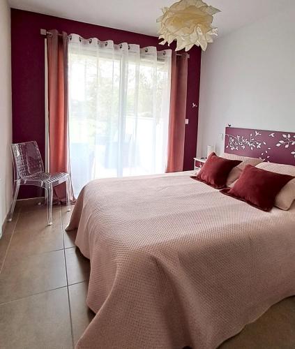 a bedroom with a large bed and a large window at Superbe T3, havre de paix, entre plage et village in Capbreton
