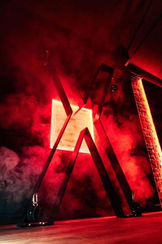 a red light in a room with smoke at Loveroom Ô Diable Des Plaisirs avec jacuzzi in Tourcoing