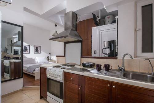 a kitchen with a sink and a stove top oven at City Cave Apartment in Heraklio