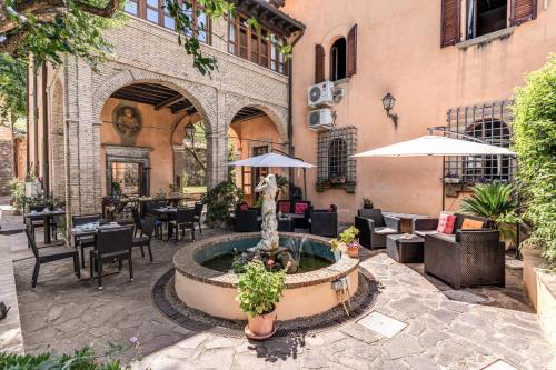 a courtyard with a fountain in front of a building at Villa Alberici in Rome