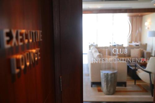 a sliding glass door with a club influencing sign in a room at InterContinental Real Santo Domingo by IHG in Santo Domingo